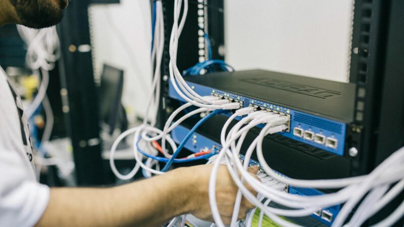 electronics engineer fixing cables on server