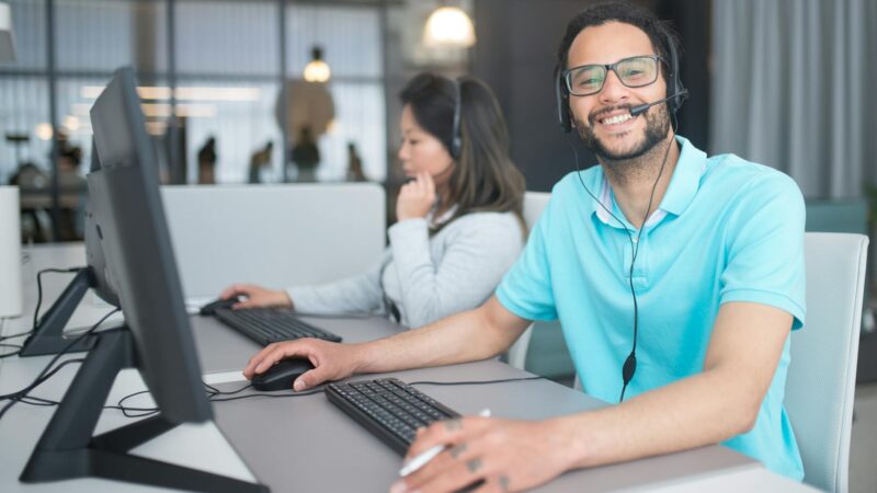 a man and a woman working in a call center